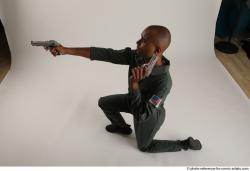 ERIC KNEELING POSE WITH GUNS